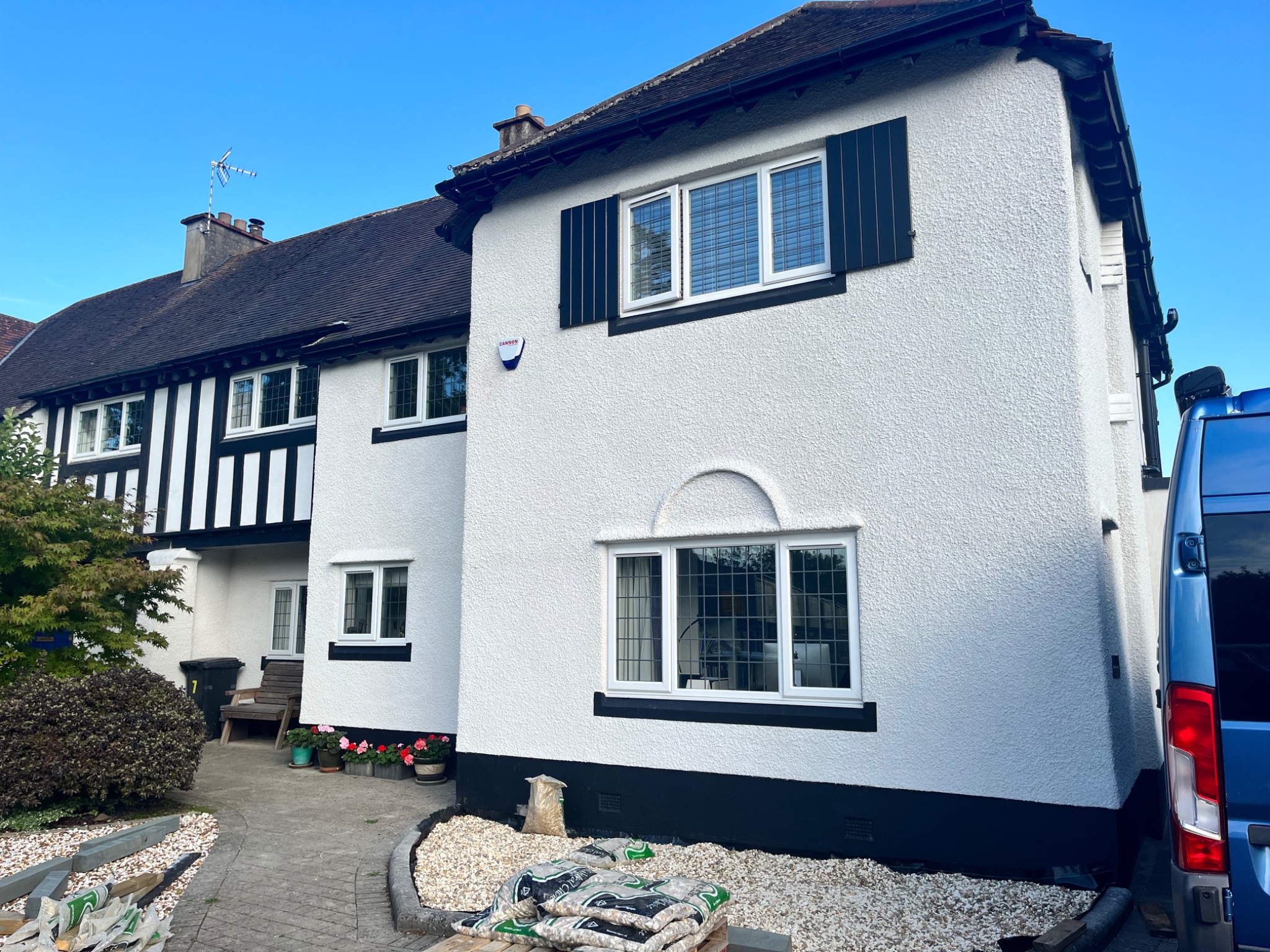 White rendered house exterior with contrasting dark trim